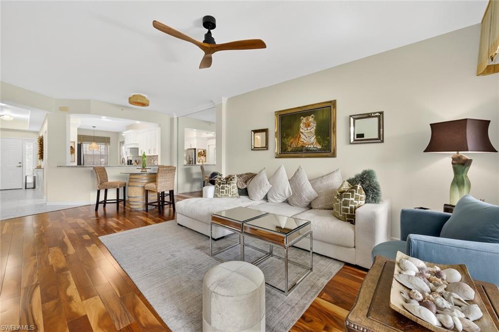 1940 Willow Bend Circle, Unit 102 Naples, FL 34109 - Photo 7 of 39 a living room with furniture and a view of kitchen