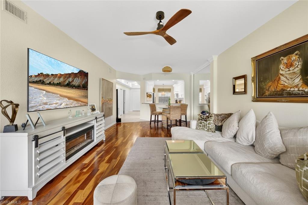 1940 Willow Bend Circle, Unit 102 Naples, FL 34109 - Photo 8 of 39 a living room with furniture and a flat screen tv