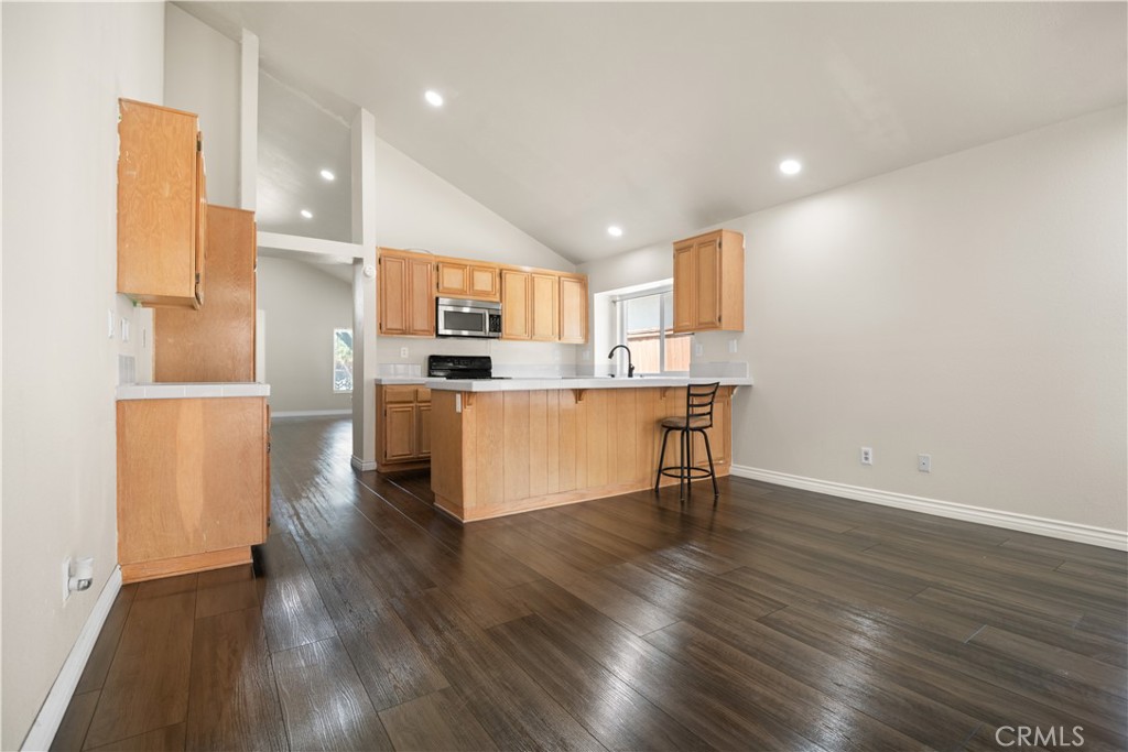 13006 August Circle Riverside, CA 92503 - Photo 11 of 19 a kitchen with kitchen island stainless steel appliances a sink and a refrigerator