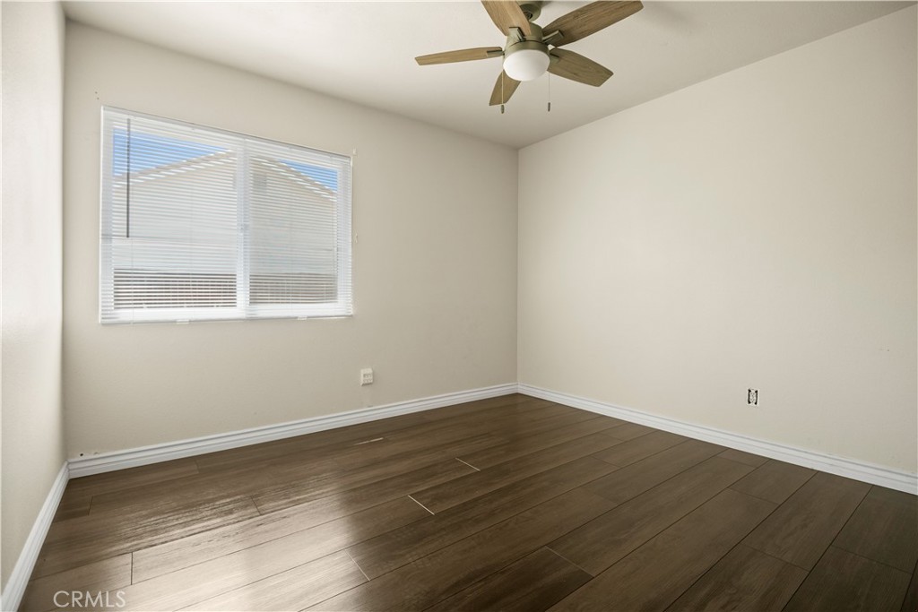 13006 August Circle Riverside, CA 92503 - Photo 12 of 19 an empty room with wooden floor fan and windows