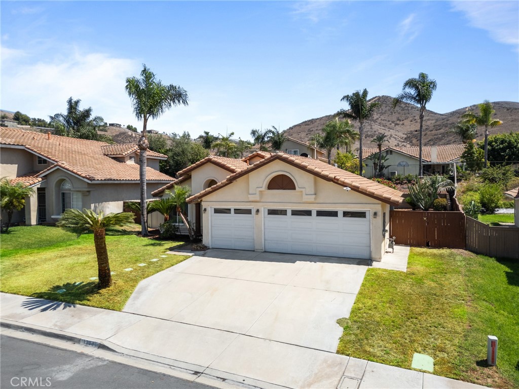 13006 August Circle Riverside, CA 92503 - Photo 2 of 19 a front view of a house with a yard and garage