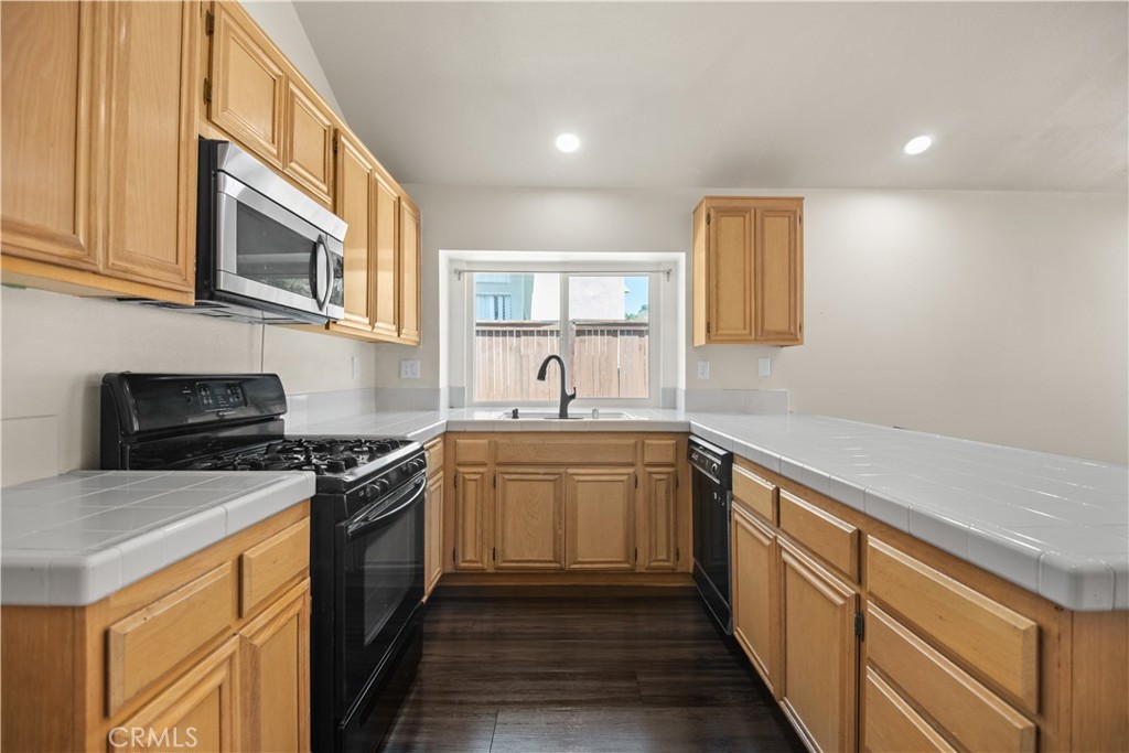 13006 August Circle Riverside, CA 92503 - Photo 5 of 19 a kitchen with stainless steel appliances granite countertop a sink stove and cabinets