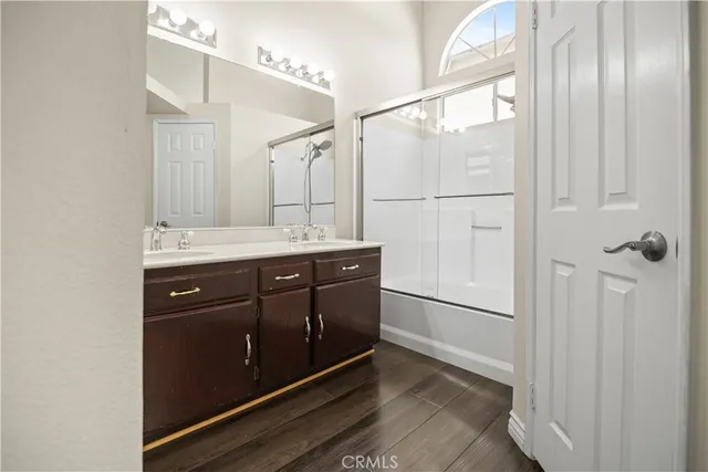 a bathroom with a double vanity sink and mirror