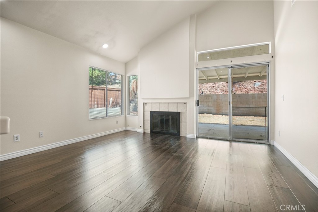 13006 August Circle Riverside, CA 92503 - Photo 10 of 19 an empty room with wooden floor and fireplace