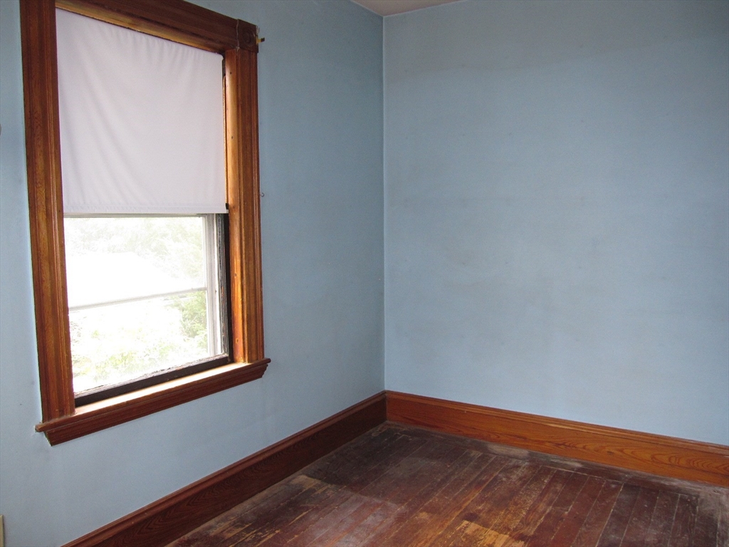 6 Broads Avenue Natick, MA 01760 - Photo 16 of 17 a view of an empty room with wooden floor and a window