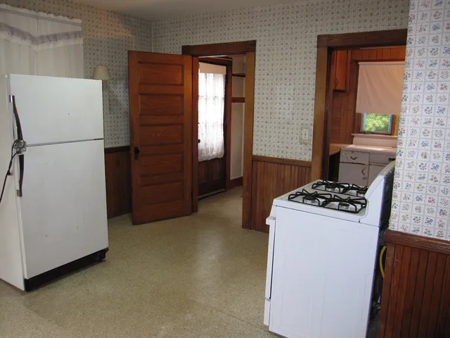 a kitchen with a refrigerator and a stove