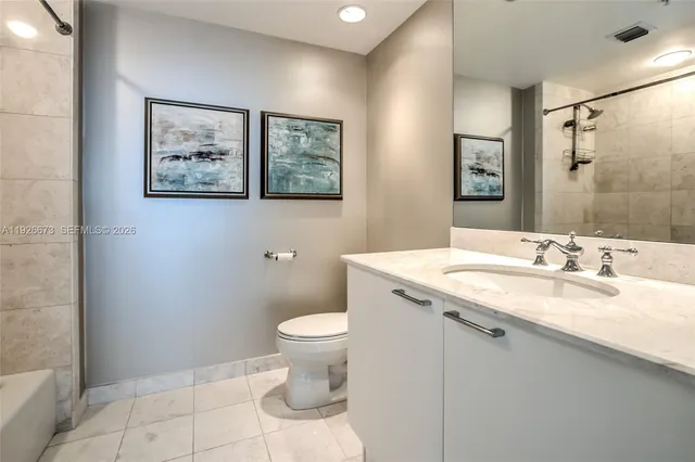 a kitchen with stainless steel appliances granite countertop a refrigerator and a stove