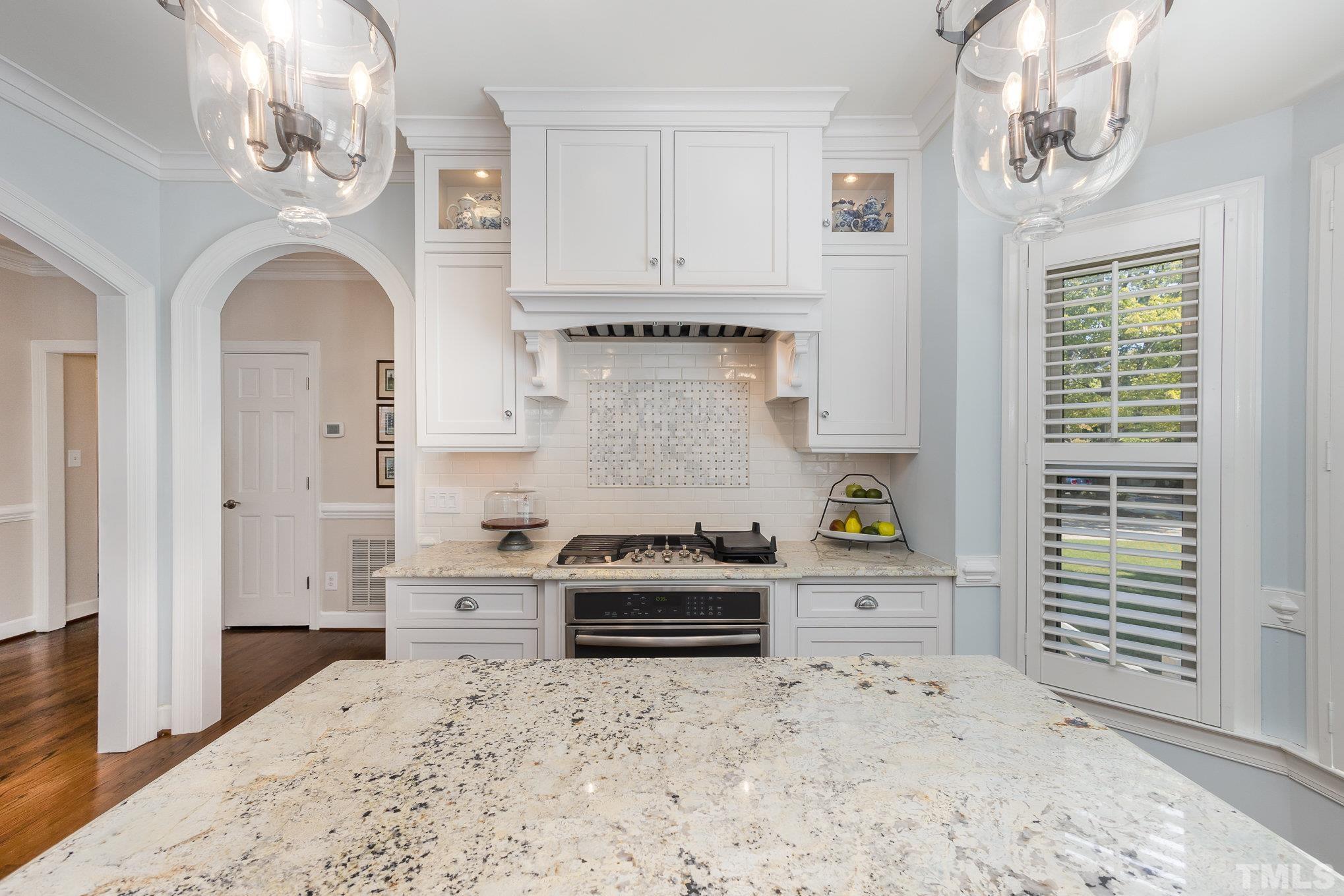 7941 Footman Way Raleigh, NC 27615 - Photo 11 of 41 a kitchen with stainless steel appliances a stove a refrigerator and cabinets