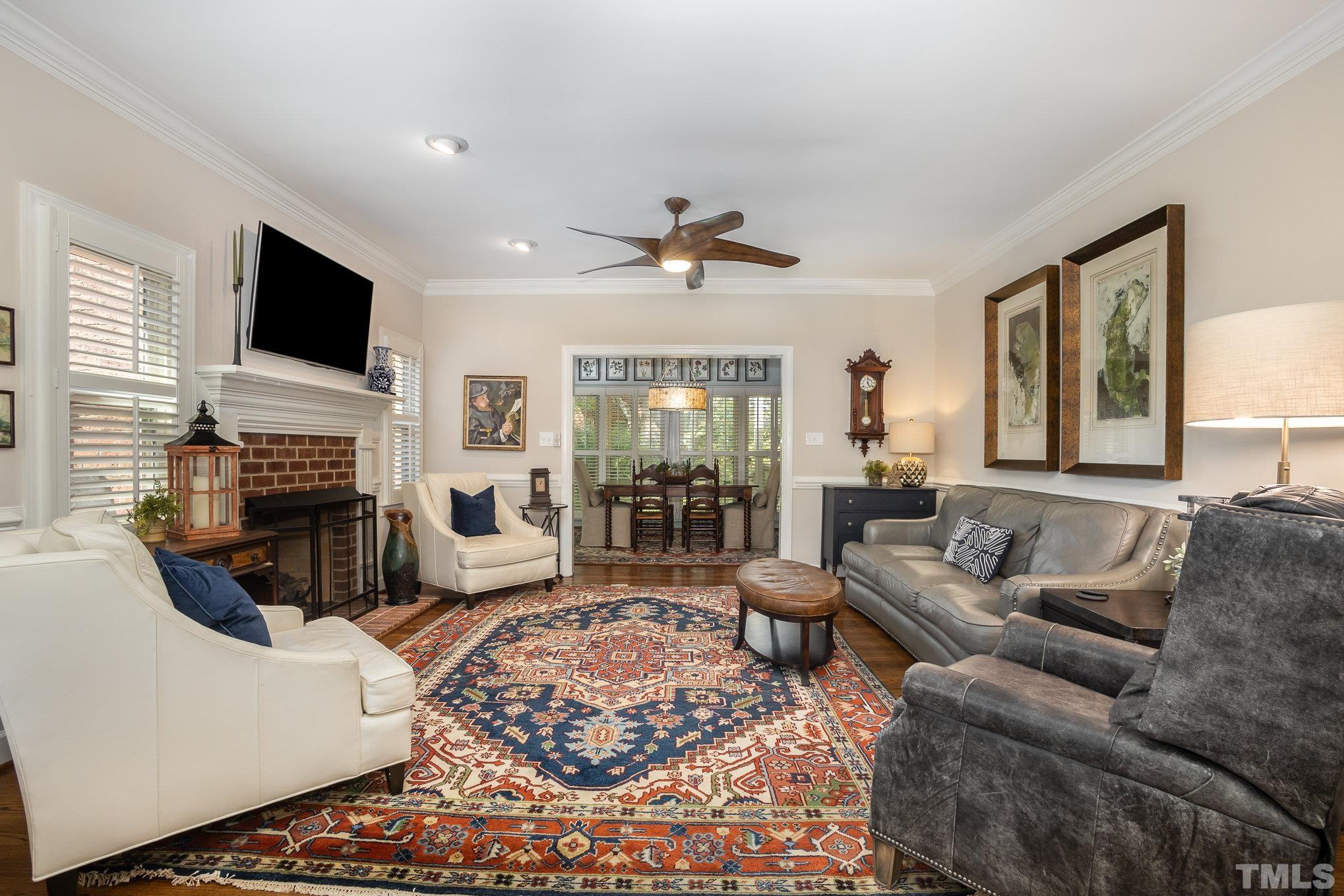 7941 Footman Way Raleigh, NC 27615 - Photo 15 of 41 a living room with fireplace furniture and a flat screen tv
