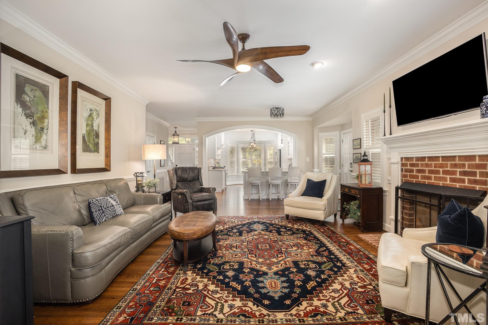 7941 Footman Way Raleigh, NC 27615 - Photo 16 of 41 a living room with fireplace furniture and a flat screen tv