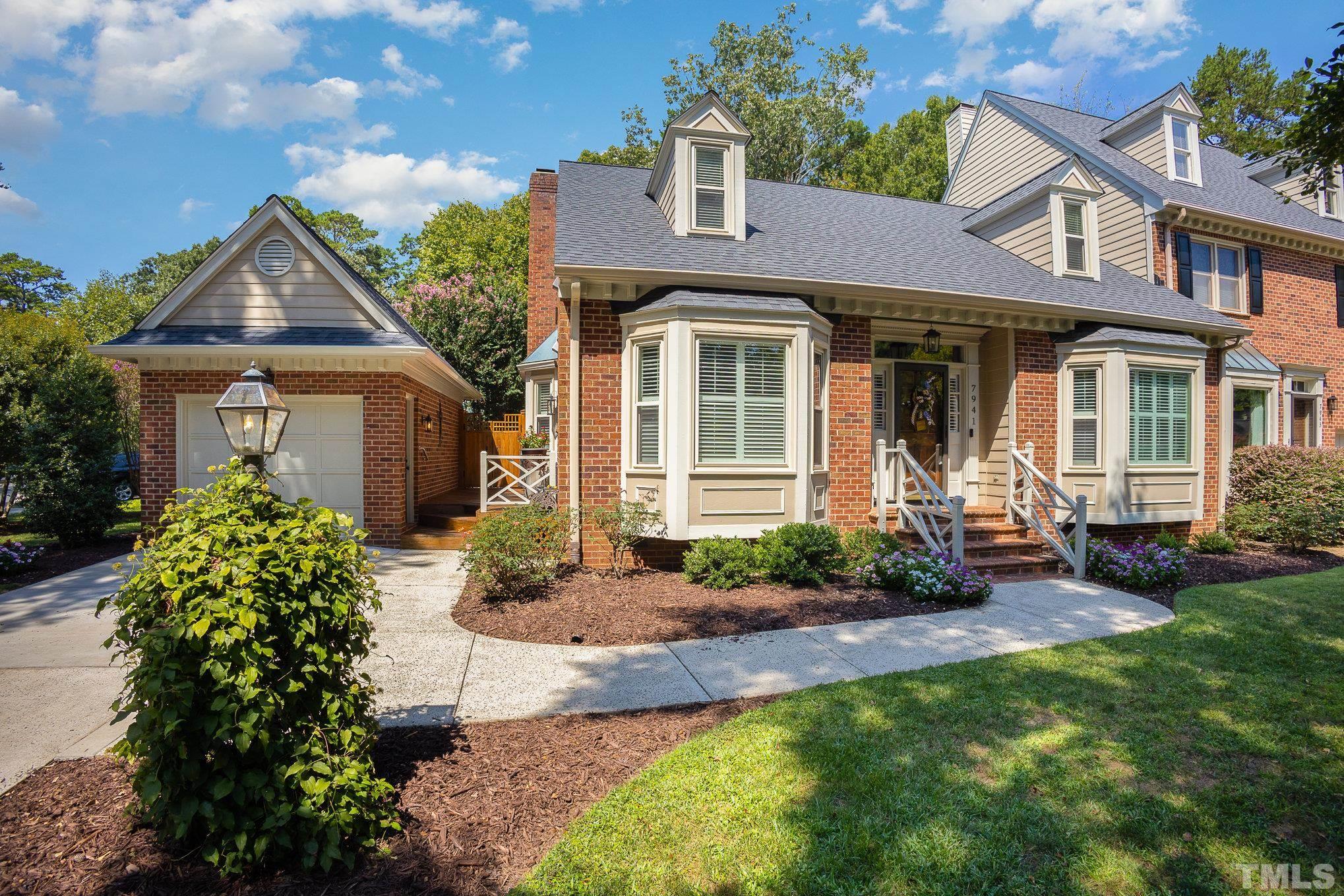 7941 Footman Way Raleigh, NC 27615 - Photo 2 of 41 a front view of a house with garden