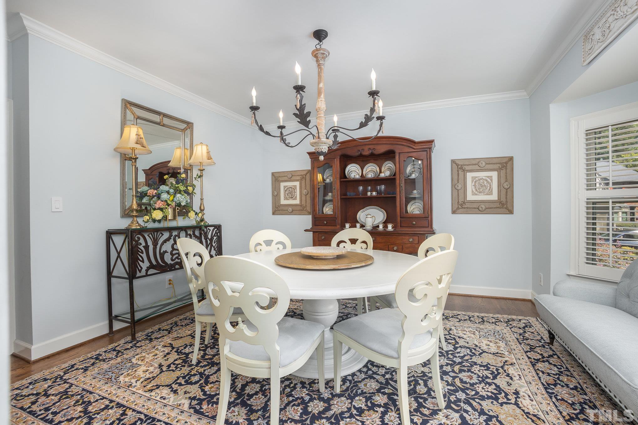 7941 Footman Way Raleigh, NC 27615 - Photo 22 of 41 a view of a dining room with furniture window and wooden floor