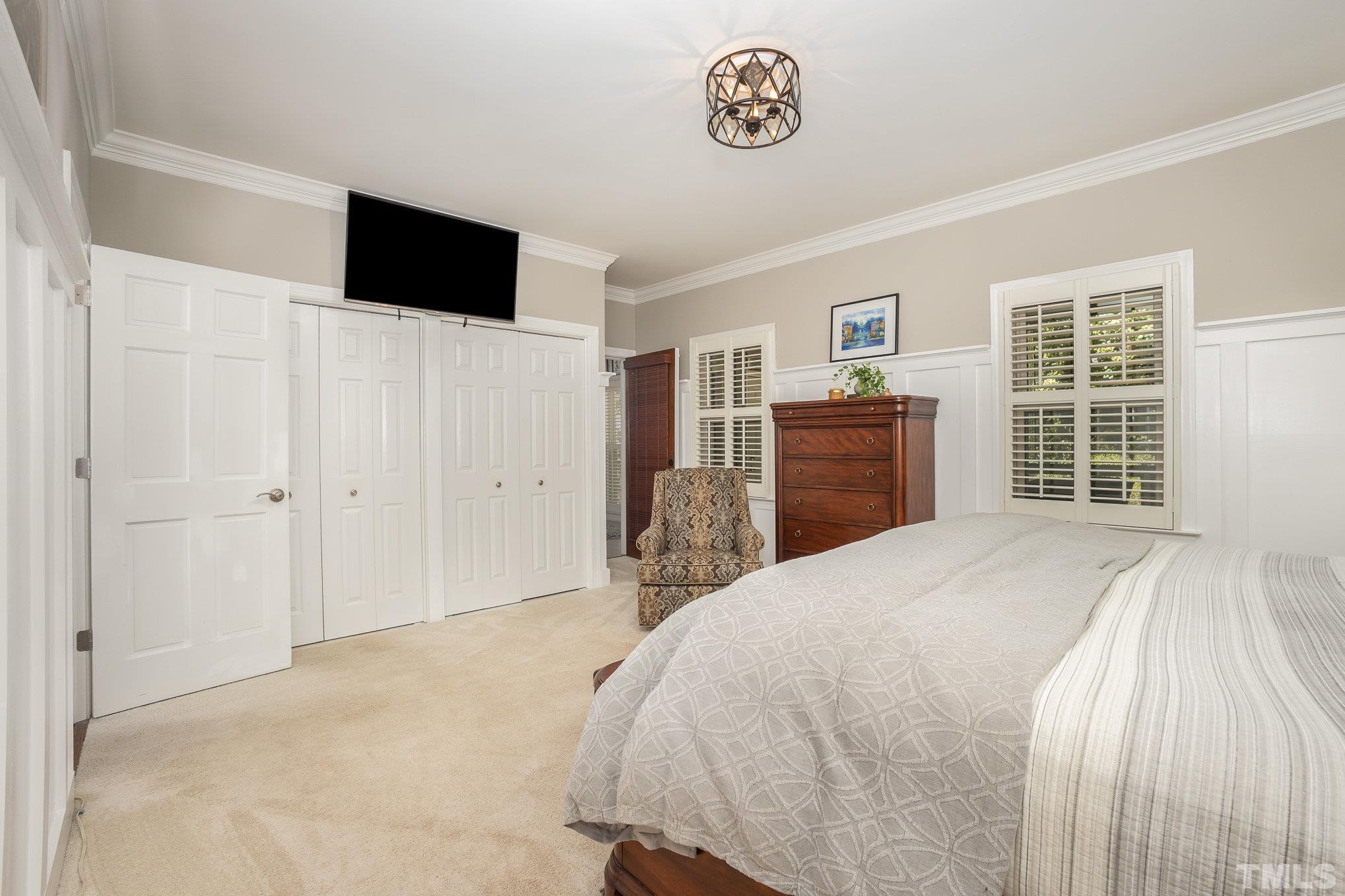 7941 Footman Way Raleigh, NC 27615 - Photo 24 of 41 a bedroom with a bed and a flat screen tv