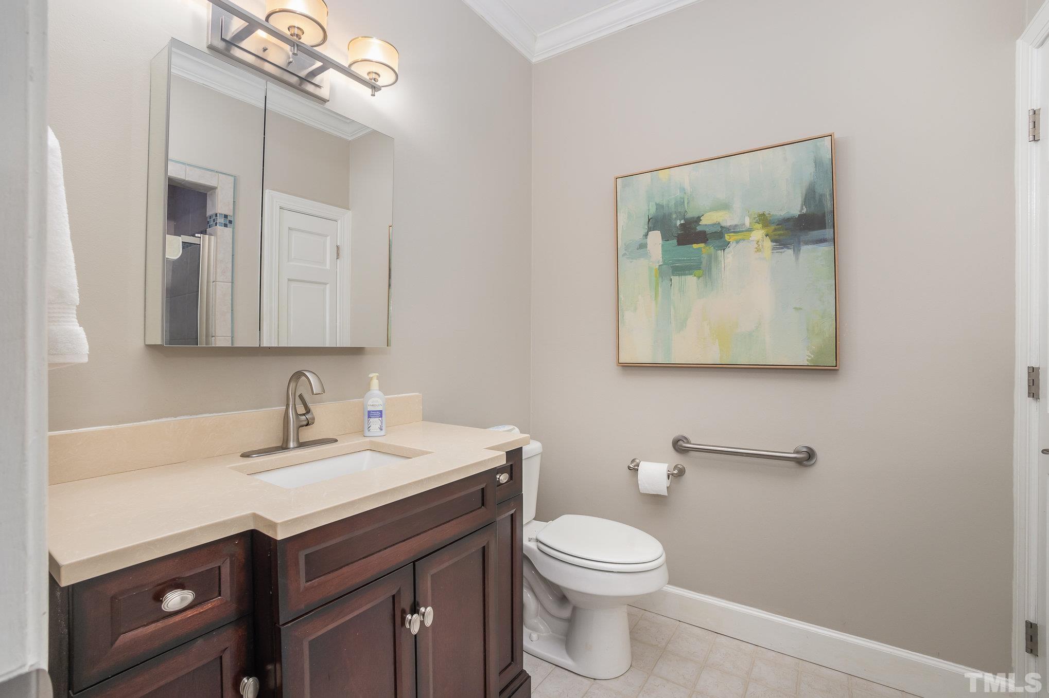 7941 Footman Way Raleigh, NC 27615 - Photo 25 of 41 a bathroom with a toilet sink and mirror