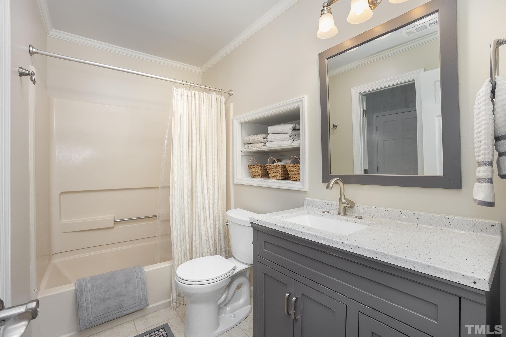 7941 Footman Way Raleigh, NC 27615 - Photo 27 of 41 a bathroom with a sink a toilet a shower and a mirror