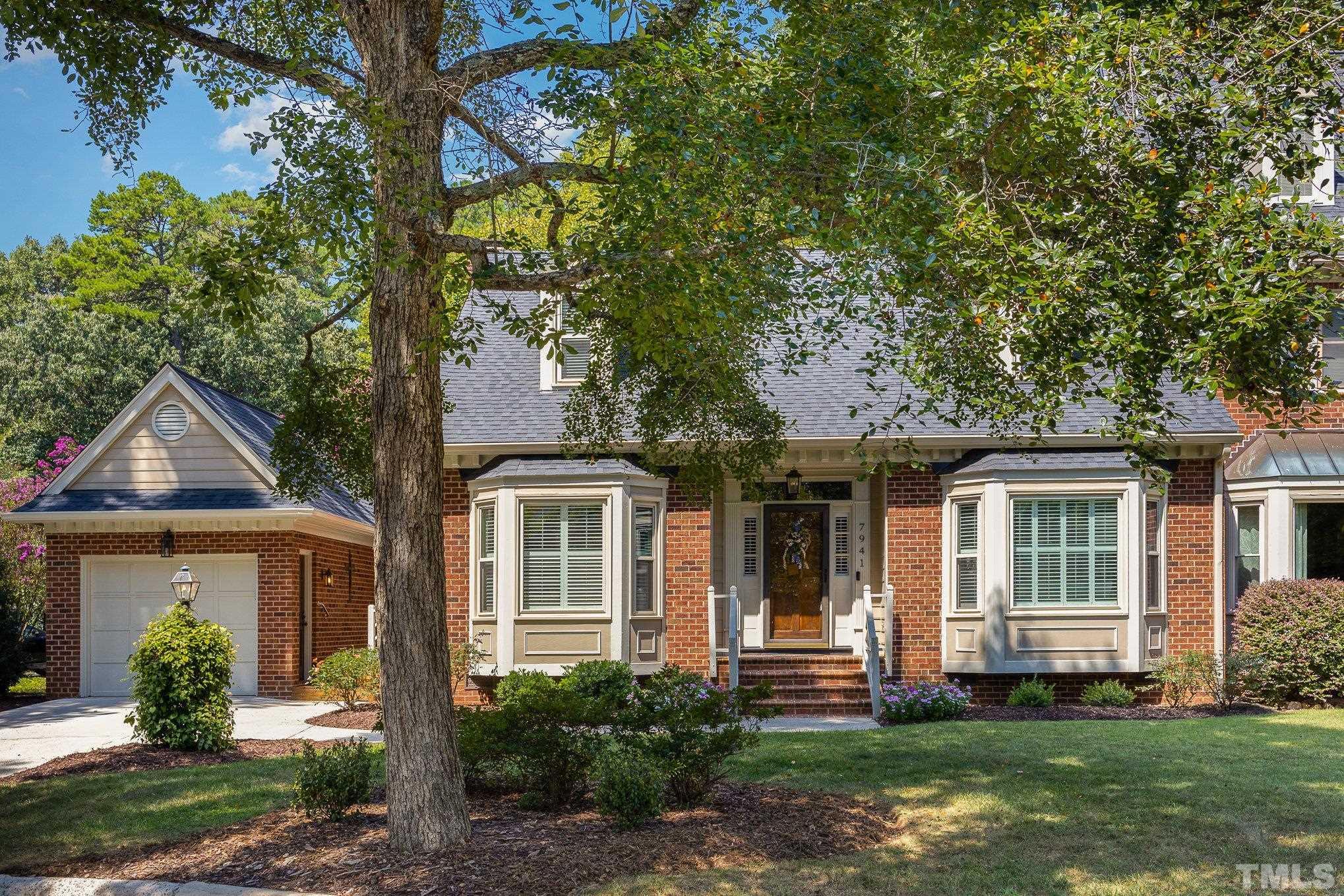 7941 Footman Way Raleigh, NC 27615 - Photo 5 of 41 a front view of a house with a yard and potted plants