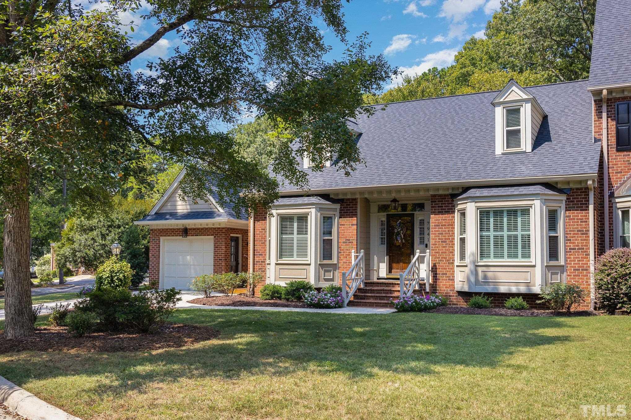 7941 Footman Way Raleigh, NC 27615 - Photo 6 of 41 a front view of a house with a garden