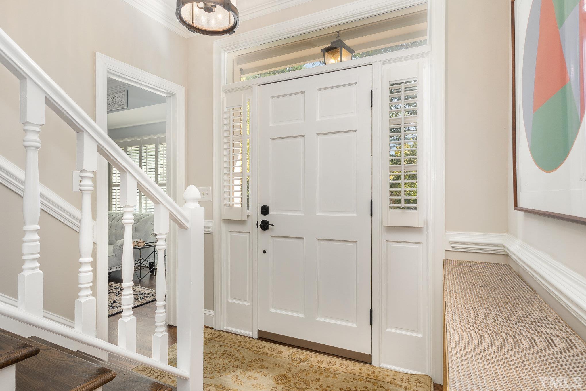 7941 Footman Way Raleigh, NC 27615 - Photo 7 of 41 a view of entryway with wooden floor and door