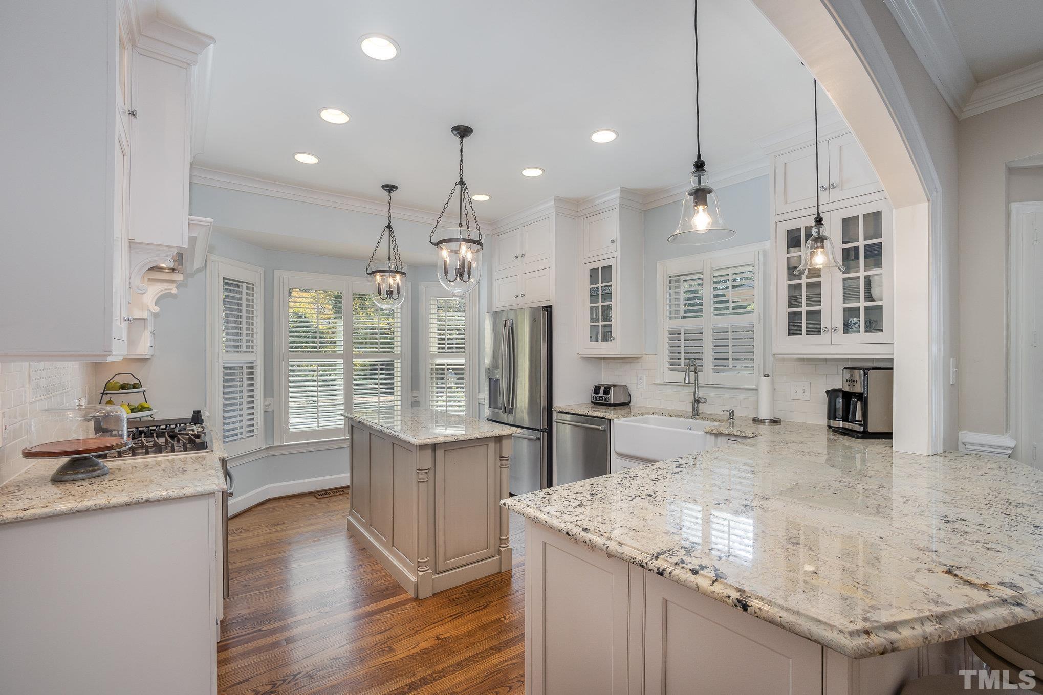 7941 Footman Way Raleigh, NC 27615 - Photo 9 of 41 a kitchen with stainless steel appliances granite countertop a sink a stove and a wooden floors
