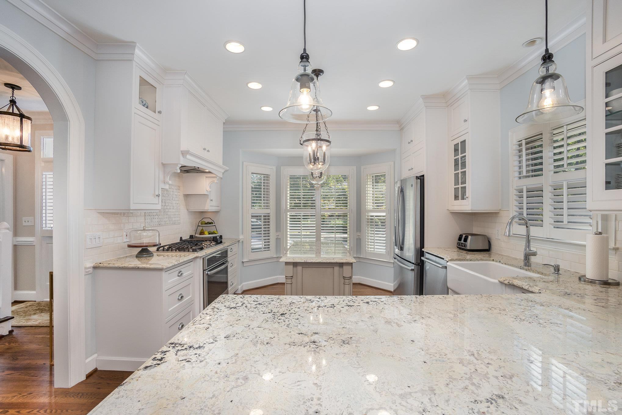 7941 Footman Way Raleigh, NC 27615 - Photo 10 of 41 a large kitchen with granite countertop a stove oven and refrigerator