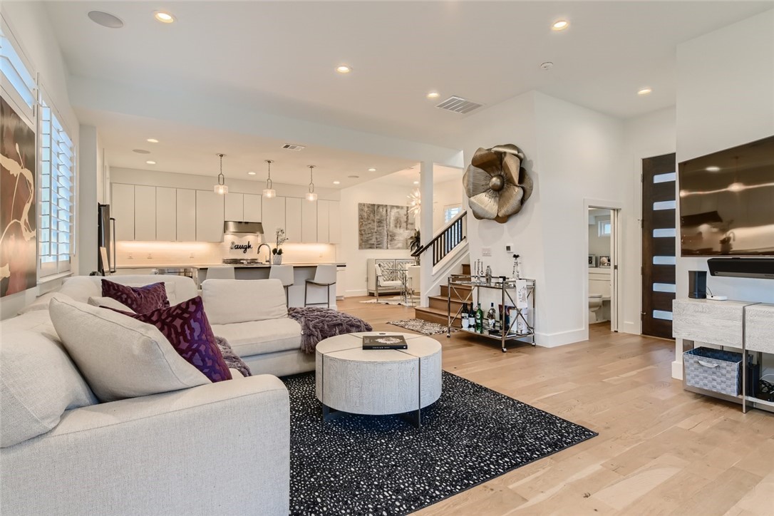 a living room with furniture and kitchen view