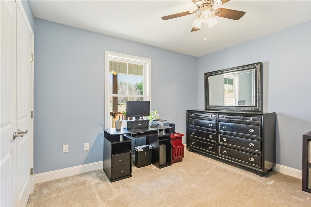 745 Dave Nix Road Seneca, SC 29678 - Photo 14 of 23 Well-lit room features soft carpeting and a functional desk setup, ideal for productivity.