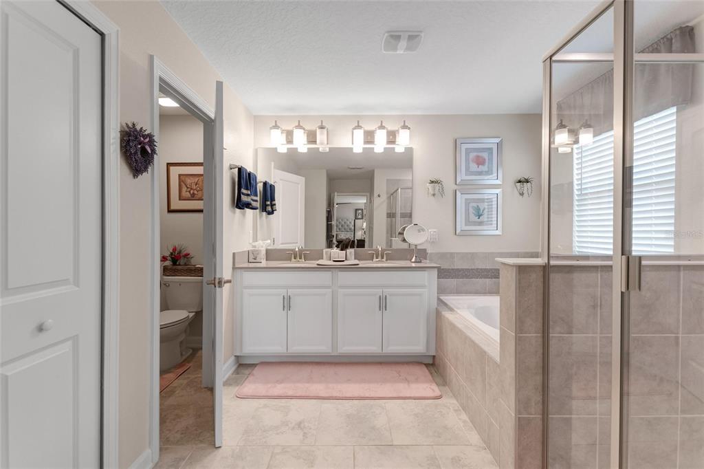 1089 Blackwolf Run Road Davenport, FL 33896 - Photo 40 of 82 a bathroom with a granite countertop sink mirror and window