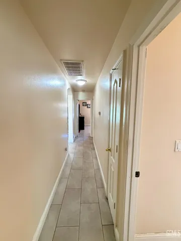 a hallway with sliding door and yard in back