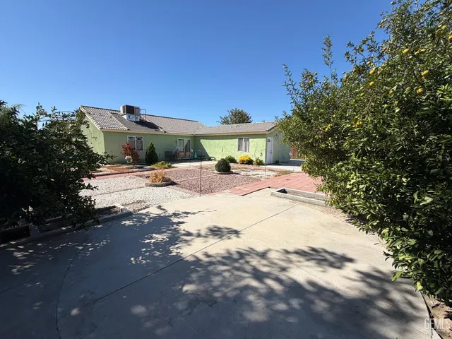 a view of a house with a tree in the background