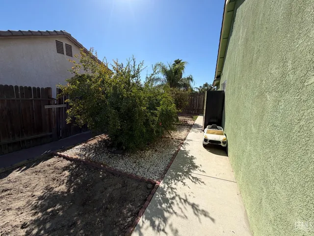 a backyard of a house with table and chairs