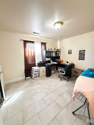 a living room with furniture a air conditioner vent and a window