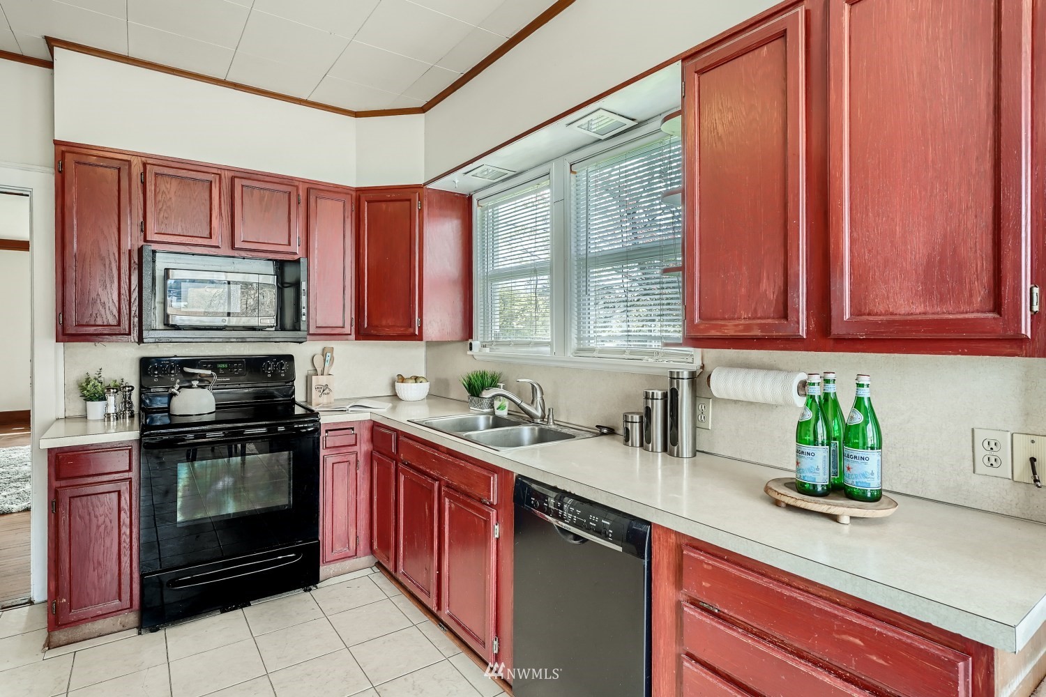 315 Wells Avenue North Renton, WA 98057 - Photo 8 of 28 a kitchen with stainless steel appliances granite countertop stove top oven a sink dishwasher and cabinets with wooden floor