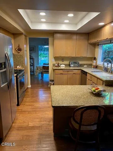 a large kitchen with granite countertop lots of counter space and breakfast area