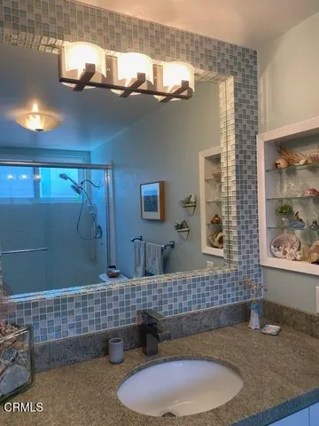 a bathroom with a sink a toilet and mirror