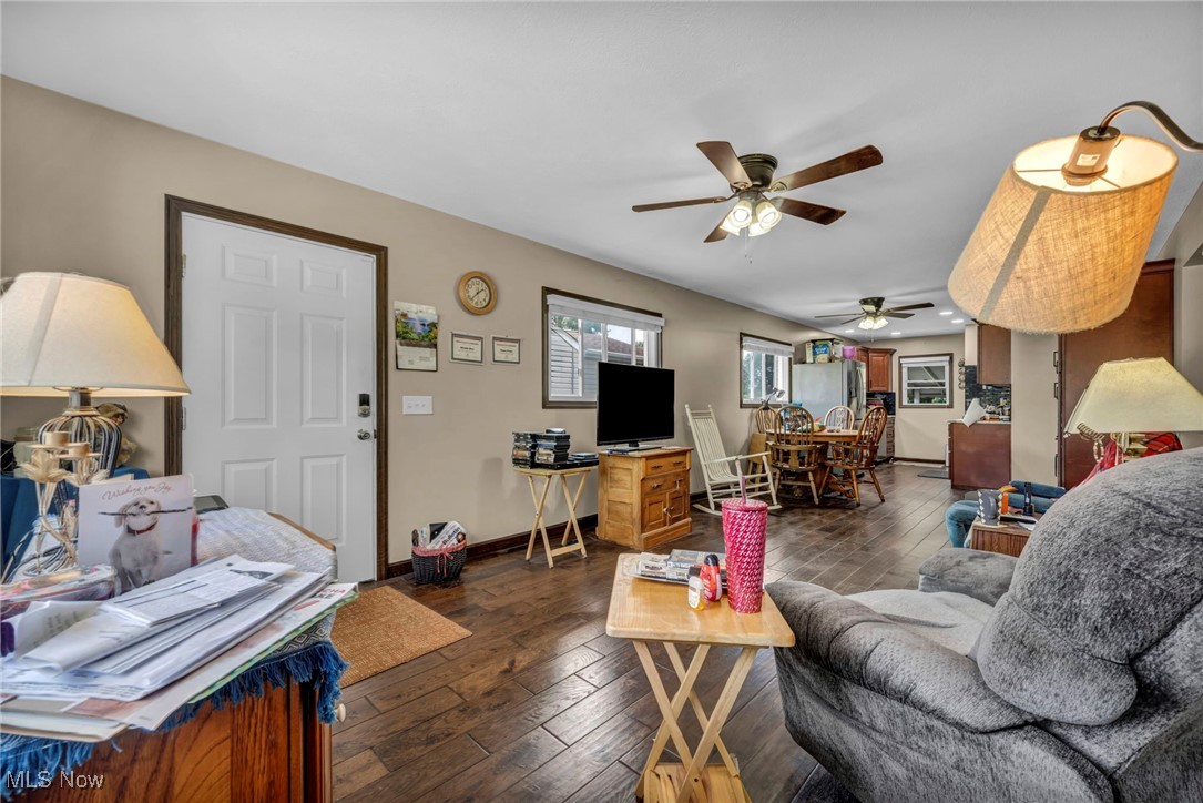 146 Hillman Road Akron, OH 44312 - Photo 38 of 49 Living area featuring a ceiling fan, dark wood-style floors, and baseboards