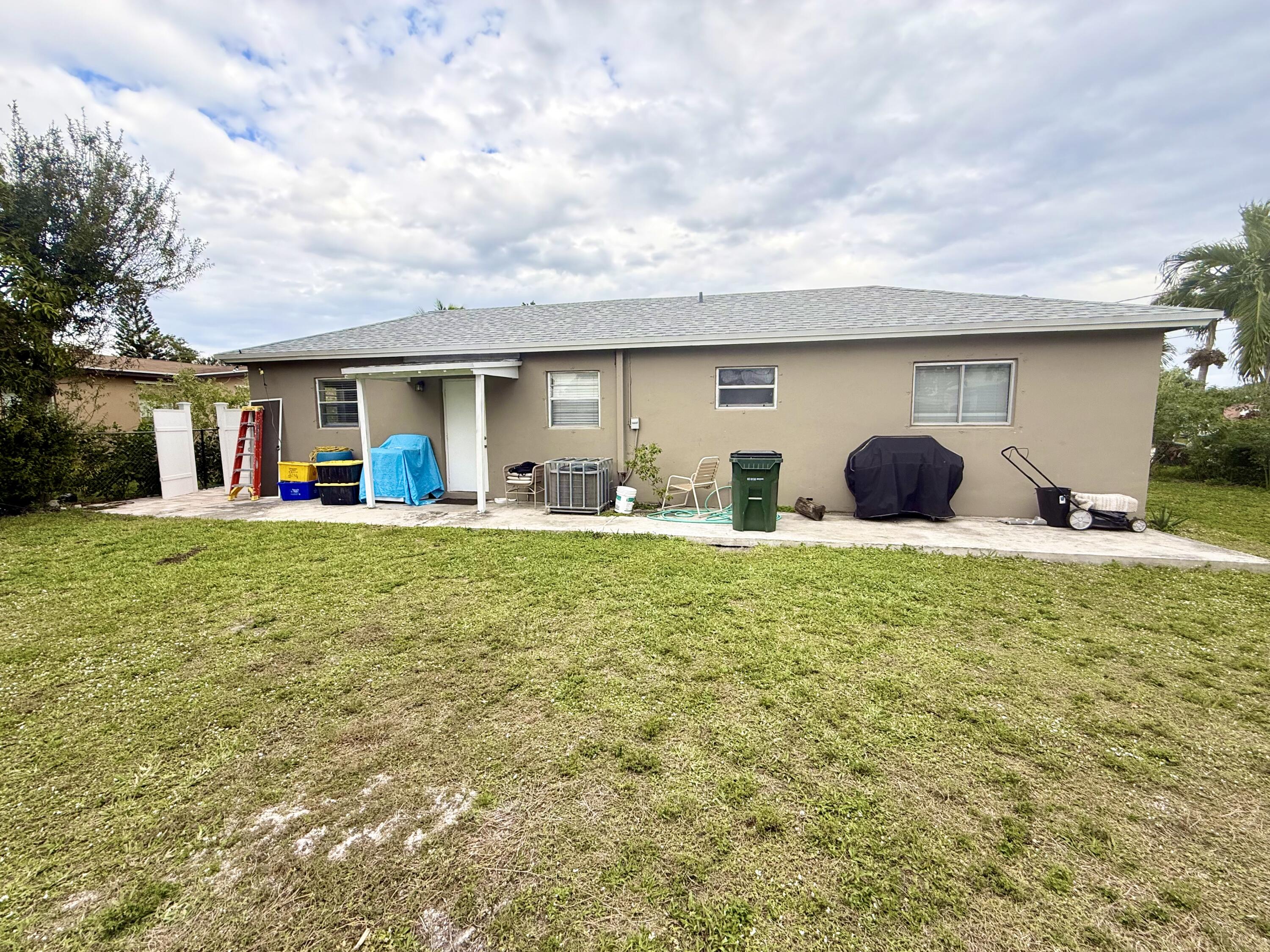 310 Washington Avenue Delray Beach, FL 33444 - Photo 12 of 16 a front view of house with yard outdoor seating and barbeque oven