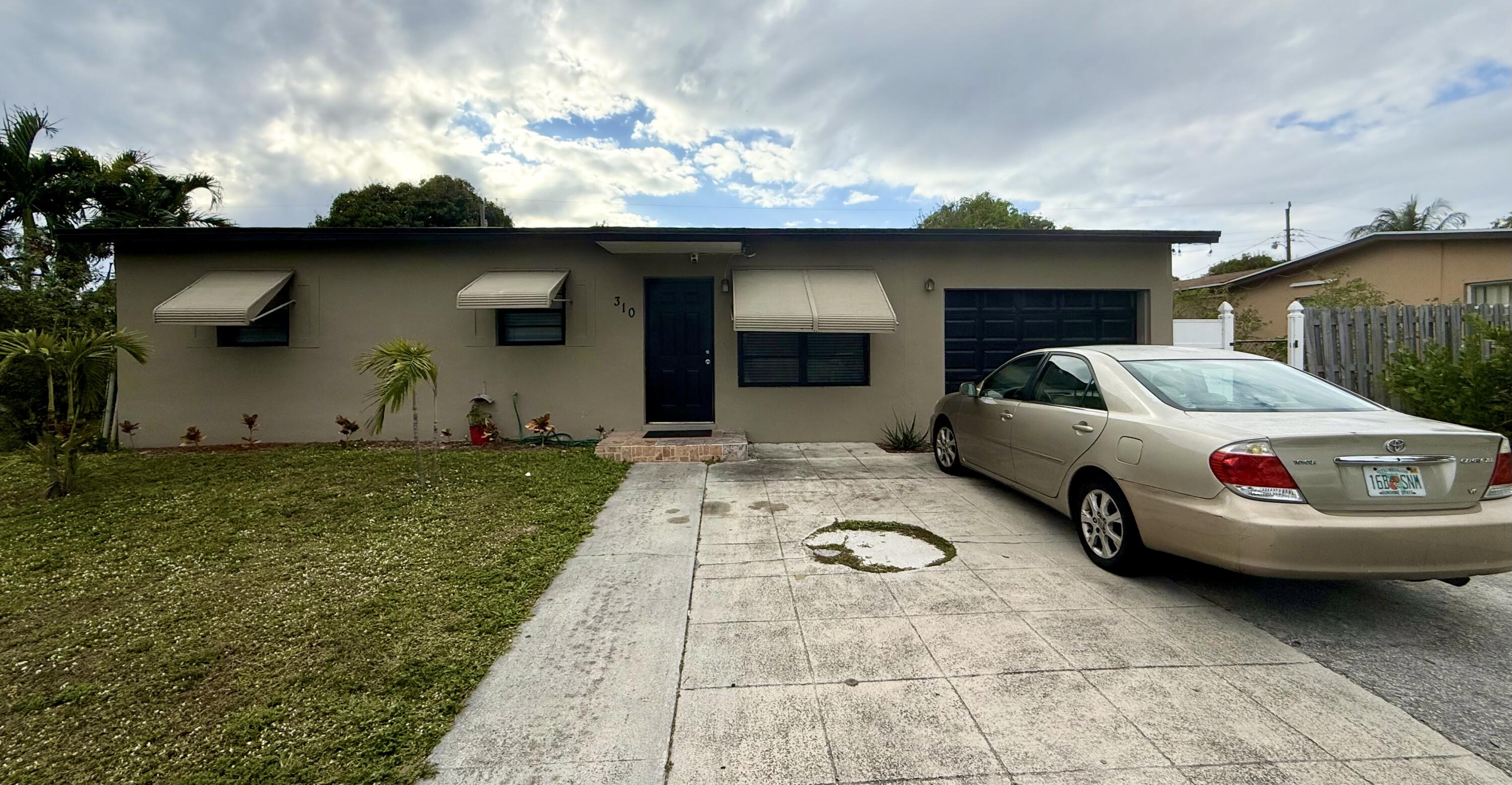 310 Washington Avenue Delray Beach, FL 33444 - Photo 14 of 16 a view of a car parked front of a house
