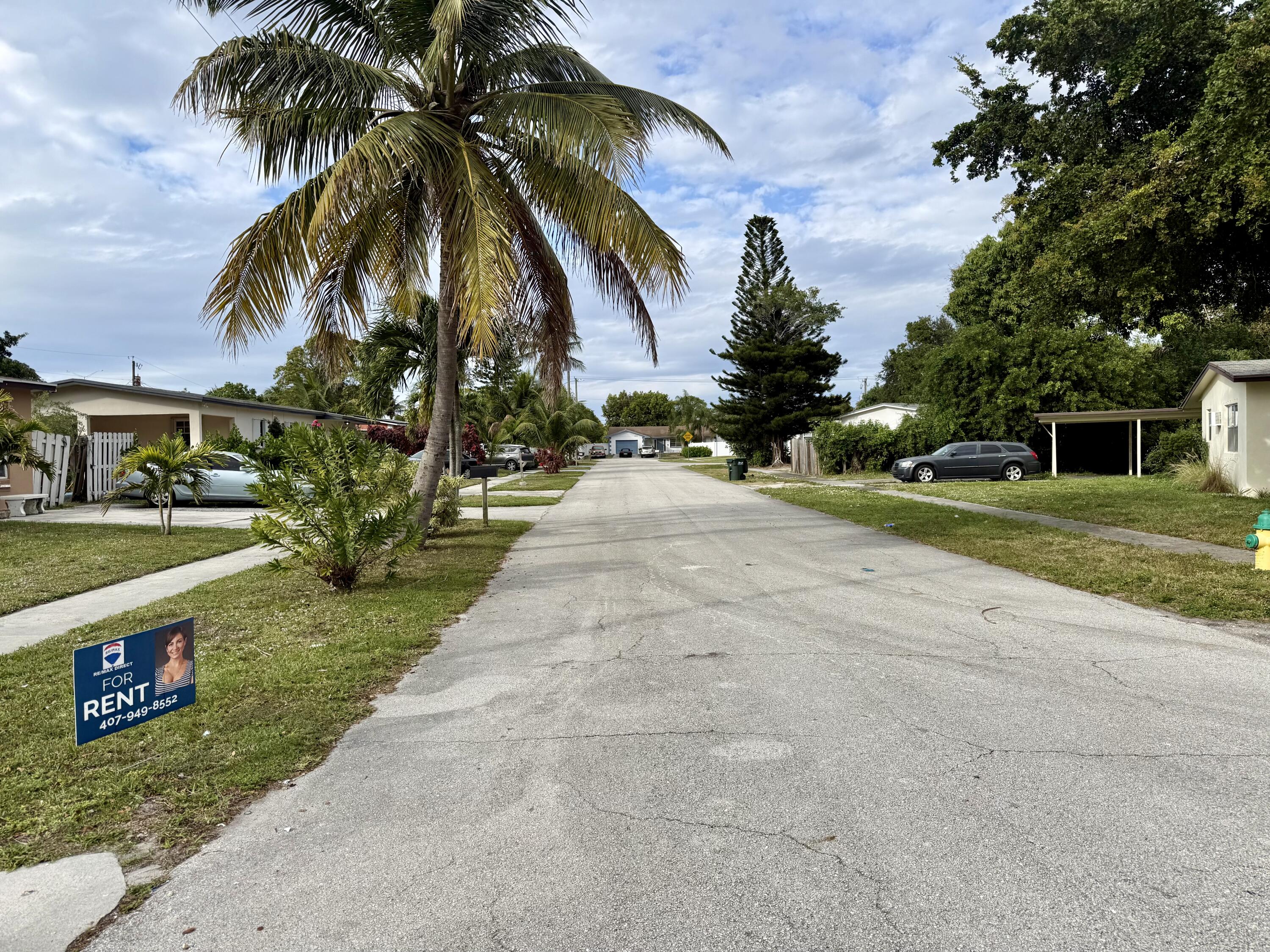 310 Washington Avenue Delray Beach, FL 33444 - Photo 15 of 16 front view of house with a yard and potted plants