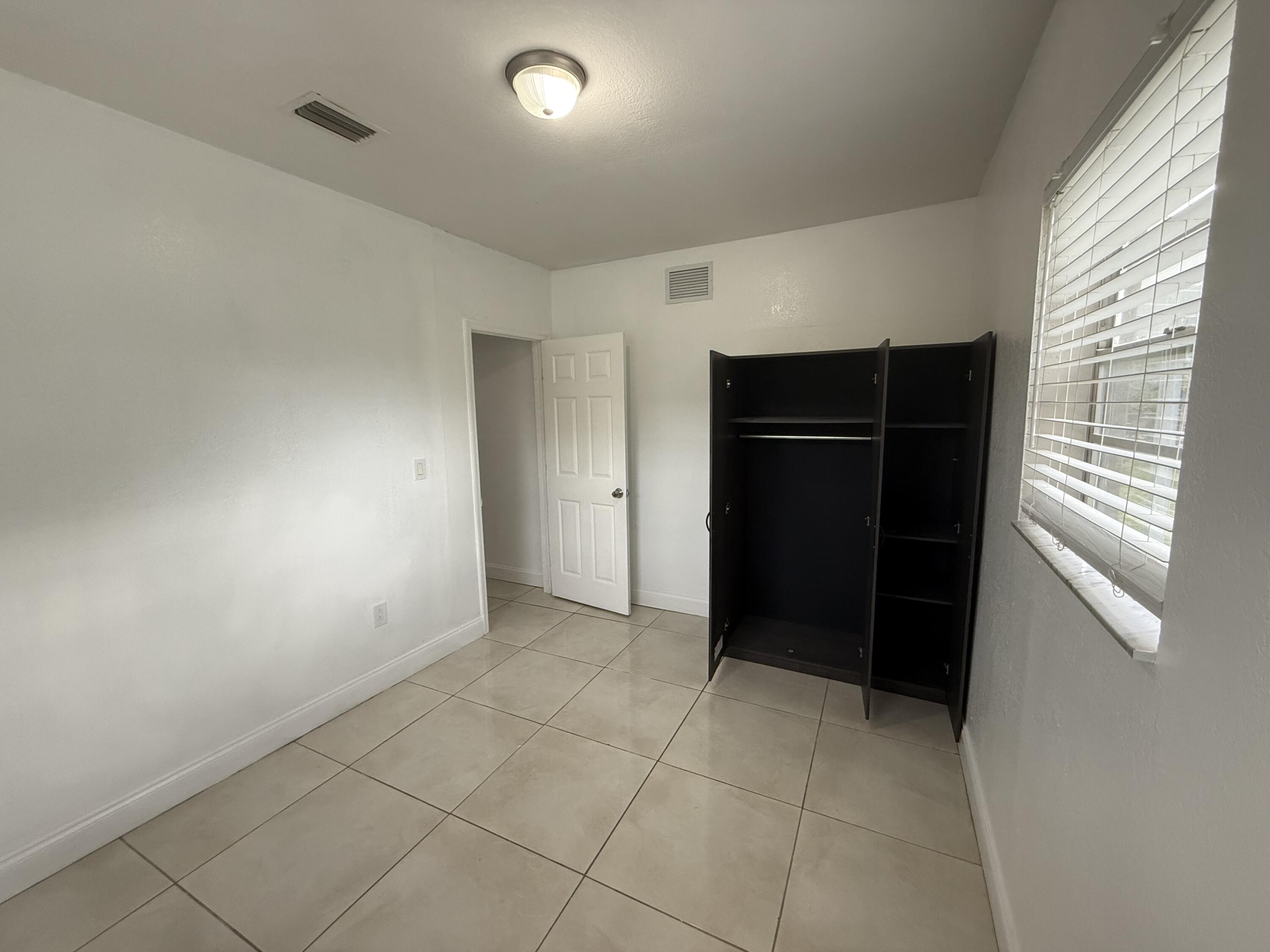 310 Washington Avenue Delray Beach, FL 33444 - Photo 7 of 16 a view of an empty room with closet and a window