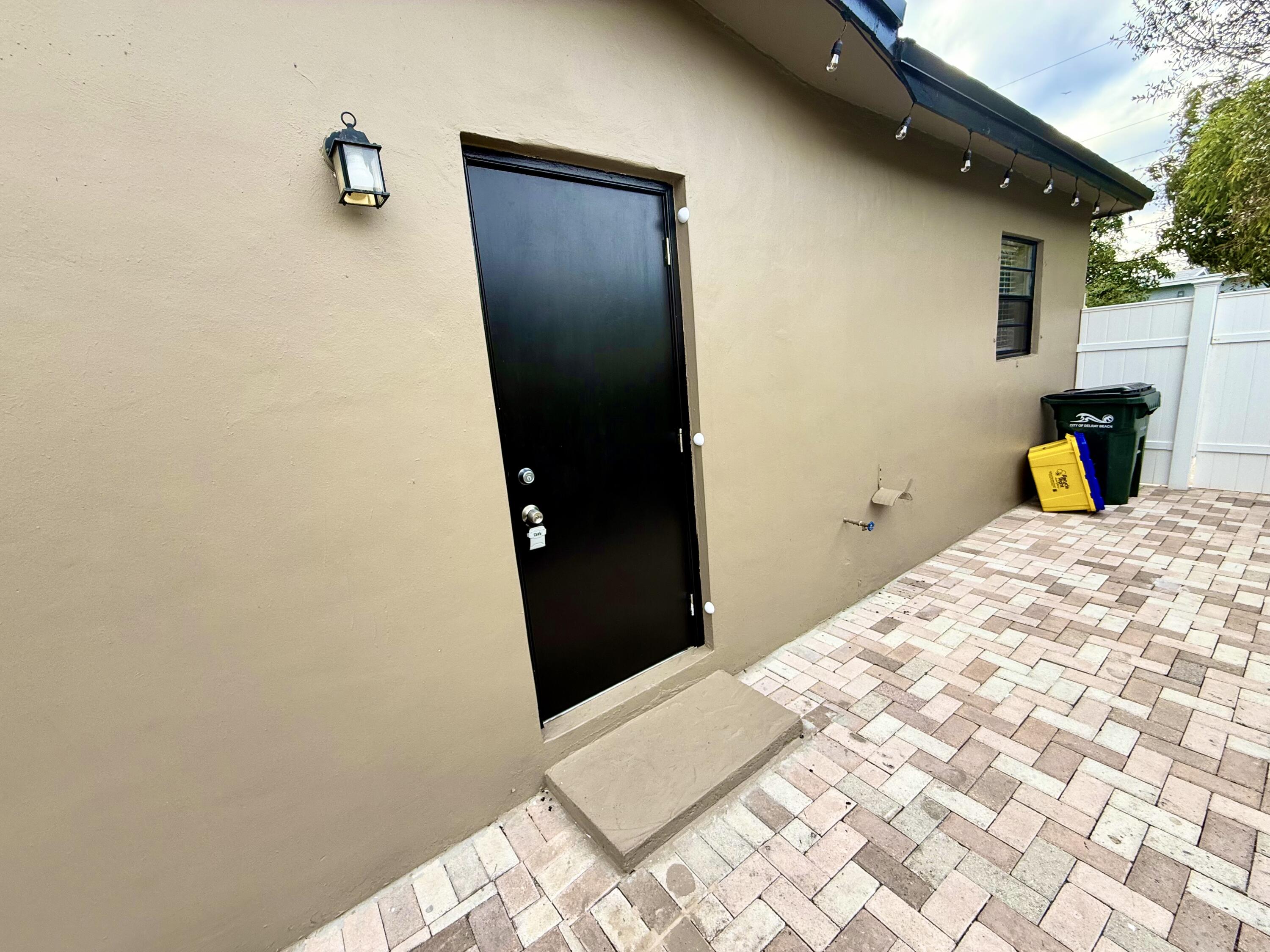 310 Washington Avenue Delray Beach, FL 33444 - Photo 8 of 16 a bedroom with a bed and a mirror