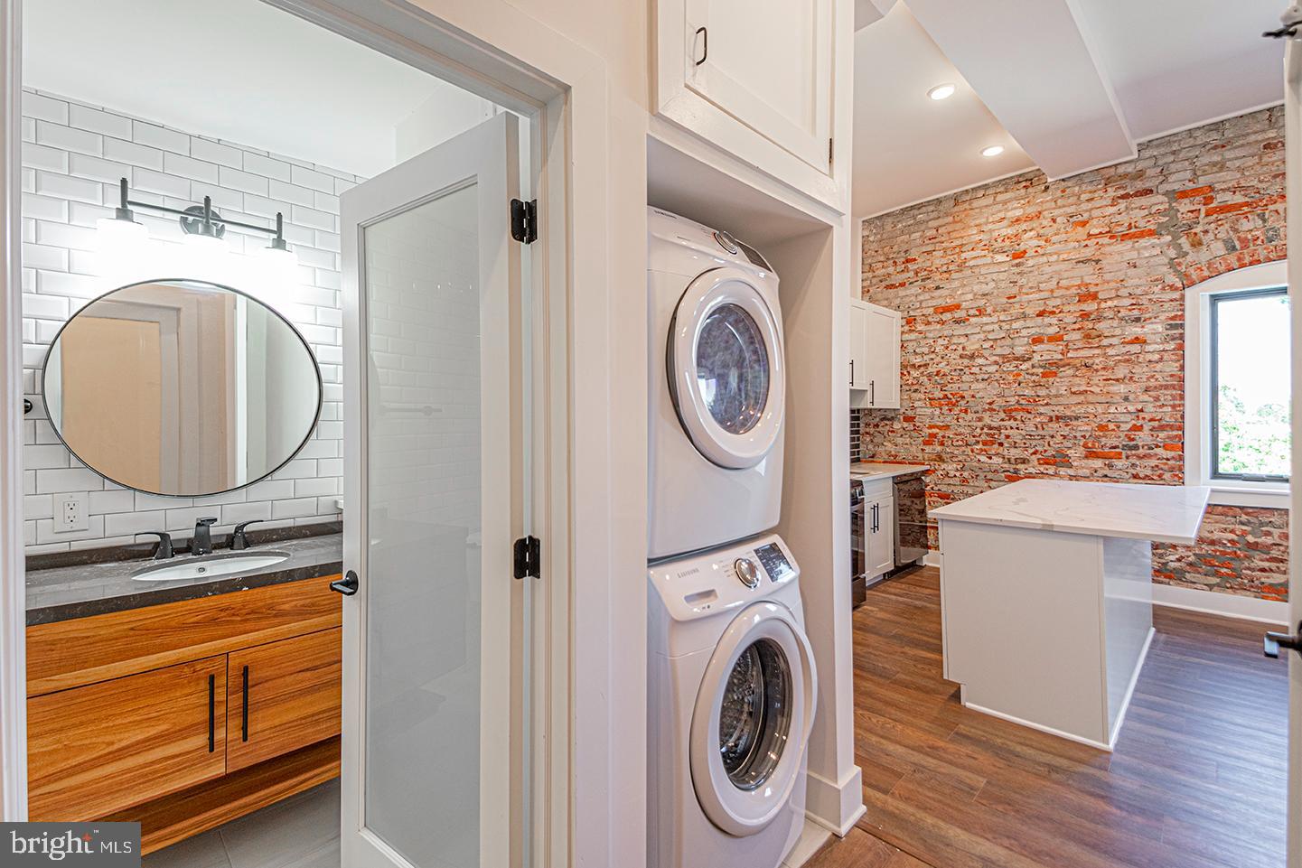 1211 Bainbridge Street, Unit 4C Philadelphia, PA 19147 - Photo 1 of 19 a bathroom with a sink a mirror and toilet