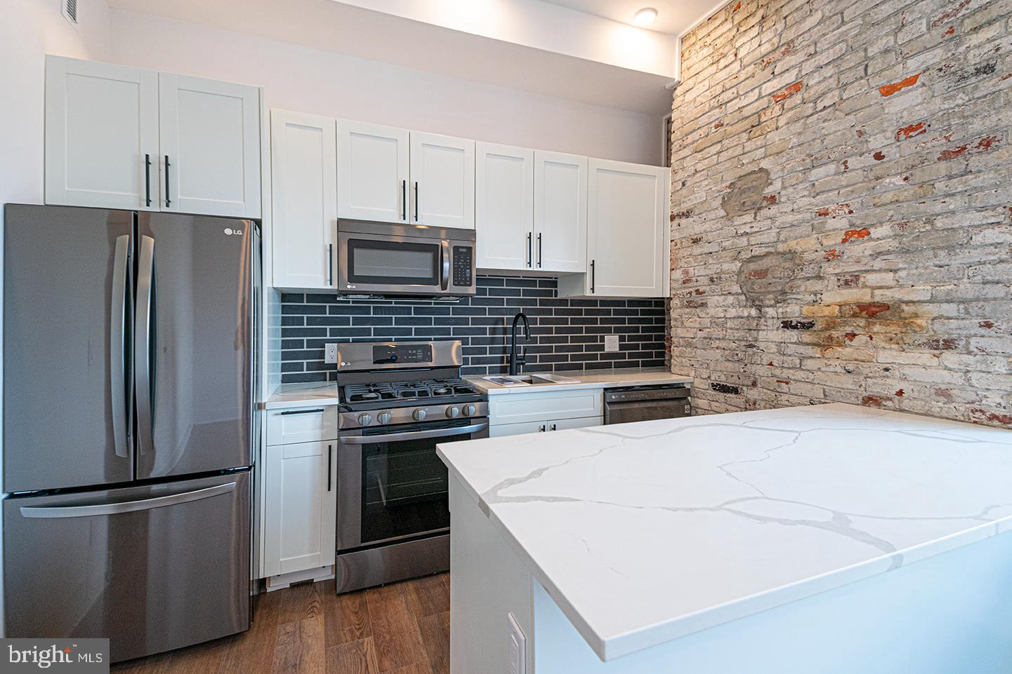 1211 Bainbridge Street, Unit 4C Philadelphia, PA 19147 - Photo 11 of 19 a kitchen with a refrigerator and a stove top oven