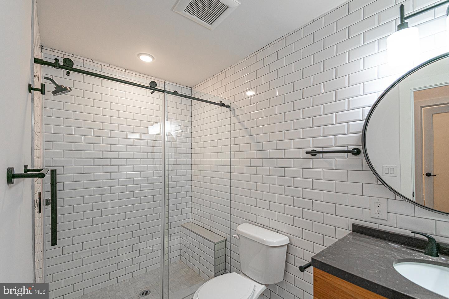 1211 Bainbridge Street, Unit 4C Philadelphia, PA 19147 - Photo 2 of 19 a bathroom with a sink toilet and shower