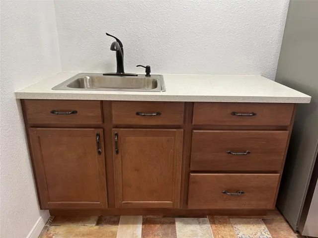a kitchen with a refrigerator and cabinets