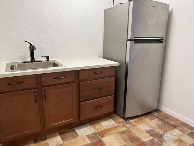 a white refrigerator freezer sitting in a kitchen