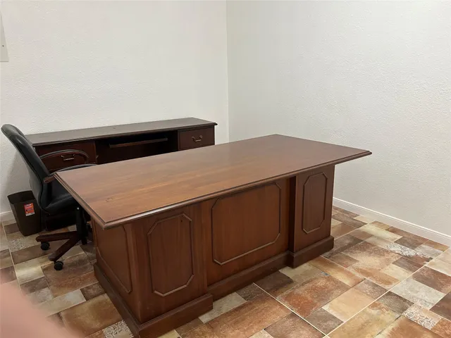 a view of workspace with wooden floor windows