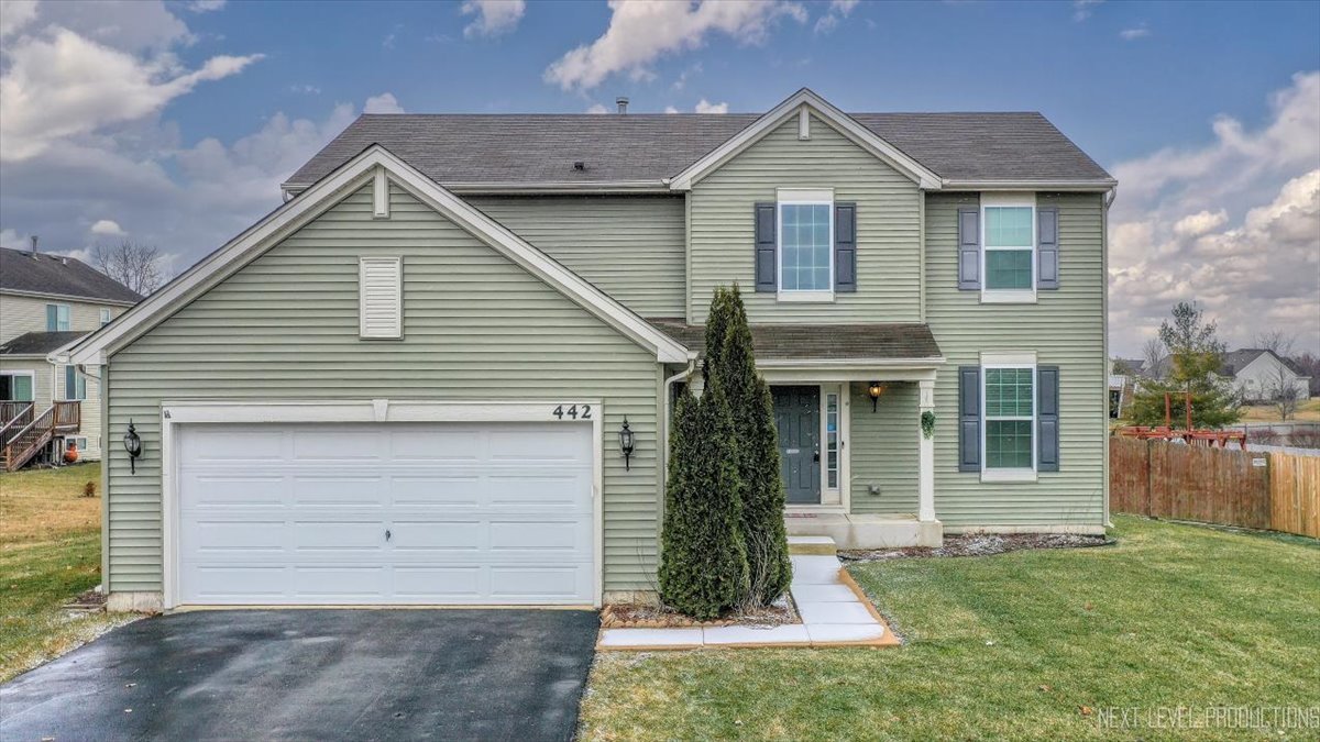 442 Windett Ridge Road Yorkville, IL 60560 - Photo 1 of 43 a front view of a house with a yard and garage