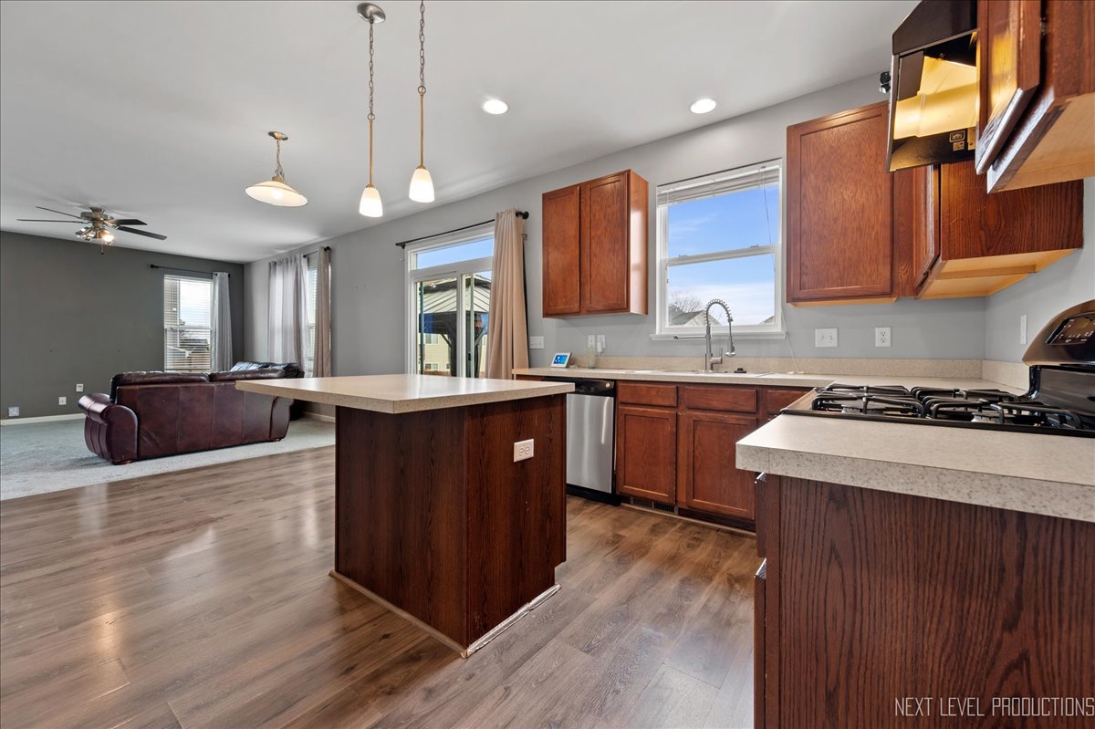 442 Windett Ridge Road Yorkville, IL 60560 - Photo 15 of 43 a kitchen with a stove a sink a center island and a window