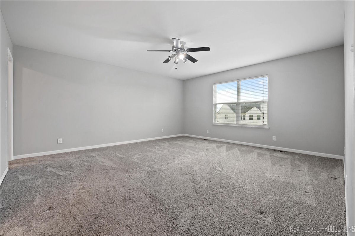 442 Windett Ridge Road Yorkville, IL 60560 - Photo 24 of 43 an empty room with windows and ceiling fan