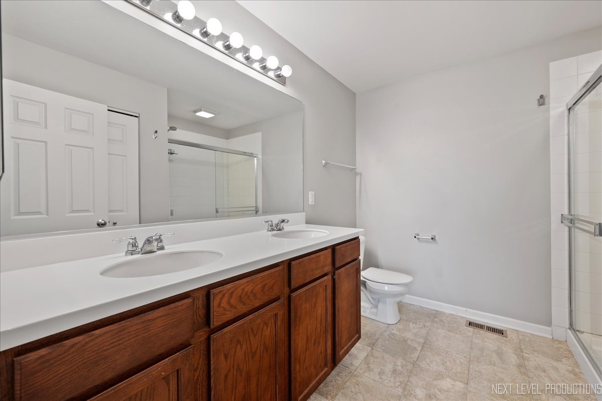 442 Windett Ridge Road Yorkville, IL 60560 - Photo 26 of 43 a bathroom with a sink double vanity and a mirror